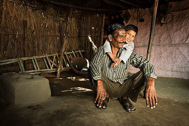 A Outstation Fathers Holding His Son On His Shoulder
