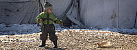 The Forgotten Casualties: Why the International Day of Innocent Children Victims of Aggression Matters | Photo- UNICEF/Romenzi : A child plays with a homemadesled made from an empty container and a length of cable, in Roj Camp, northeast Syria.