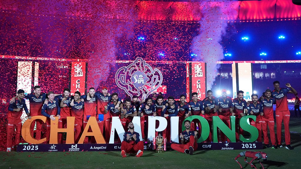 Royal Challengers Bengaluru players celebrate with the winners trophy after their win in the Indian Premier League final cricket match against Punjab Kings at Narendra Modi Stadium in Ahmedabad, India, Wednesday, June 4, 2025. - | Photo: AP/Ajit Solanki