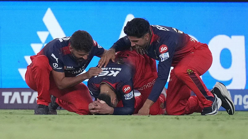 Royal Challengers Bengalurus Virat Kohli, centre, reacts after their win. AP