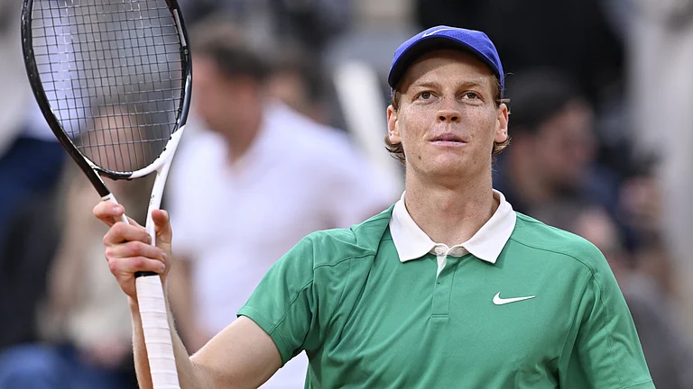 Jannik Sinner acknowledges the fans at the French Open after his quarter-final win - null