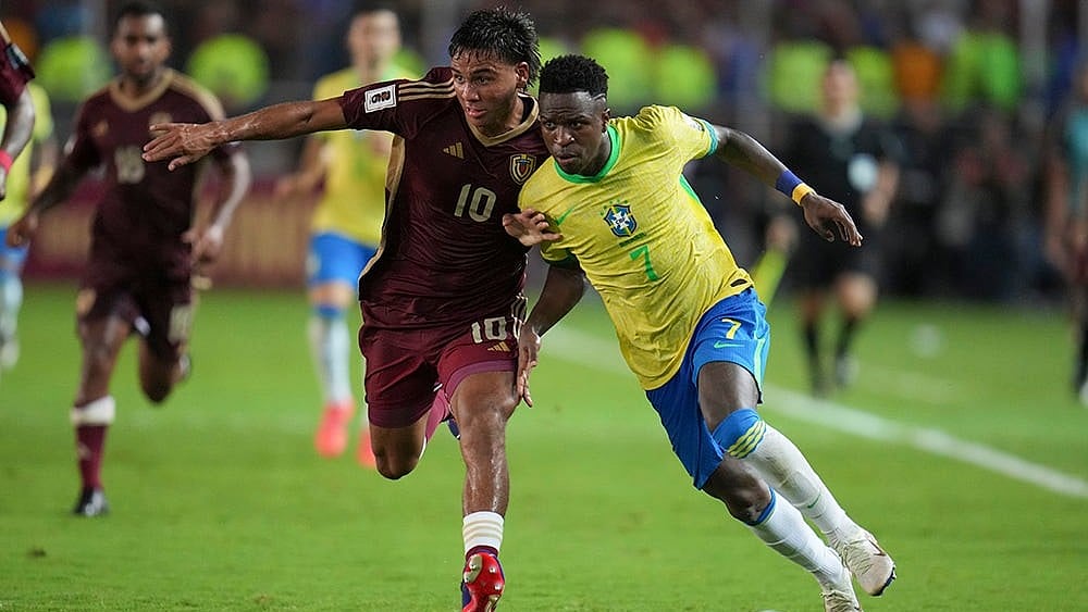 | Photo: AP/Ariana Cubillos : FIFA World Cup 2026 Qualifiers: Brazil's Vinicius Junior and Venezuela's Telasco Segovia battle for the ball.