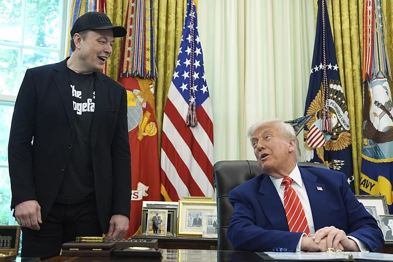 Billionaire entrepreneur Elon Musk (L) with US President Donald Trump (R) - AP