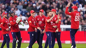 Owen Humphreys/PA via AP : England's Liam Dawson, 3rd right, celebrates the wicket of West Indies' Johnson Charles, caught by Jos Buttler during the first men's international Twenty20 match at Banks Homes Riverside, Chester-le-Street, England.