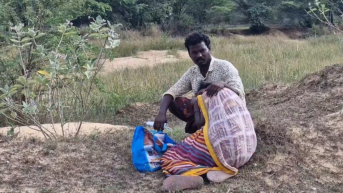 | -  : Ankamma, the mother of nine-year-old Venkatesh, at his burial site in Tamil Nadu 