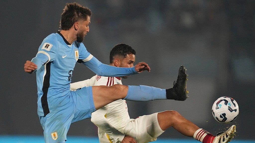 AP : Uruguay's Rodrigo Bentancur, left, reaches for the ball alongside Venezuela's Miguel Navarro during a qualifying soccer match for the FIFA World Cup 2026 at Centenario Stadium in Montevideo.