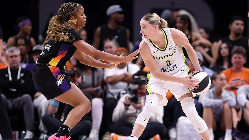 Paige Bueckers #5 of the Dallas Wings controls the ball