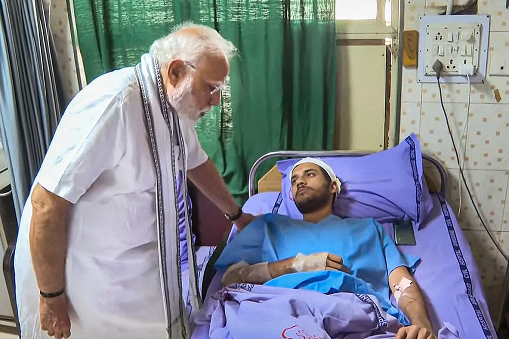Prime Minister Narendra Modi meets an injured of the Air India plane crash