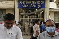 Death Toll Rises in Ahmedabad Plane Crash AP Photo/Rafiq Maqbool : People wait outside the autopsy room of a hospital near the Air India plane crash site in Ahmedabad