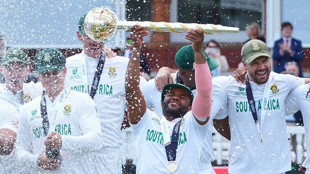 AP : South Africa captain Temba Bavuma holds the winner's trophy and celebrates with teammates after their win in the ICC World Test Championship 2025 final against Australia at Lord's.