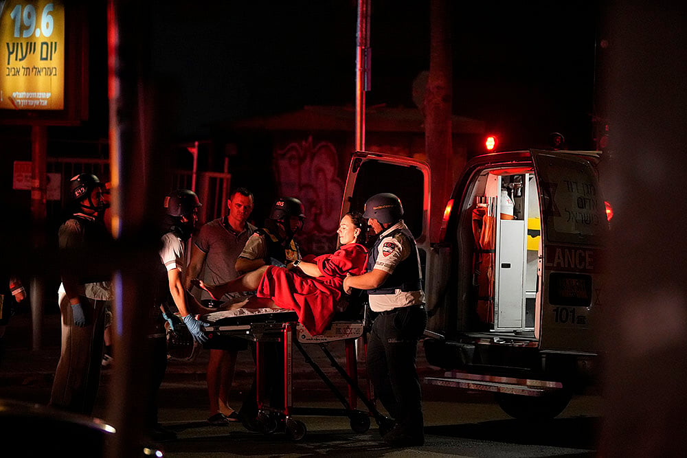 Israel Iran Mideast Wars; Paramedics evacuate a wounded woman