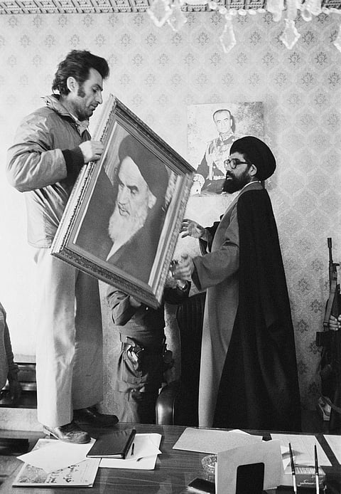 Palace employees replace the portrait of the Shah Reza Pahlavi with a portrait of the Ayatollah Ruhollah Khomeini at the Niavaran Palace in Tehran. 