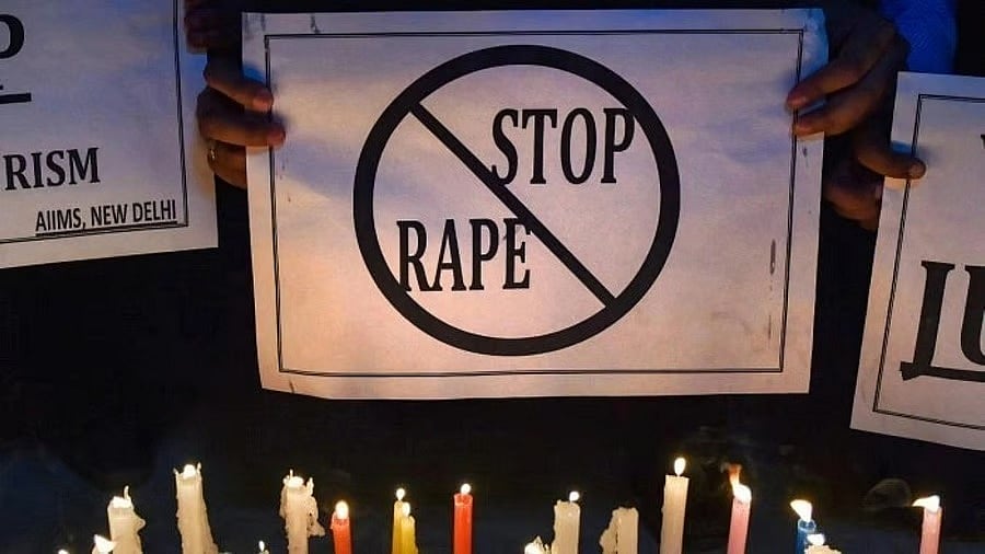 A placard being shown at an anti-rape protest - PTI
