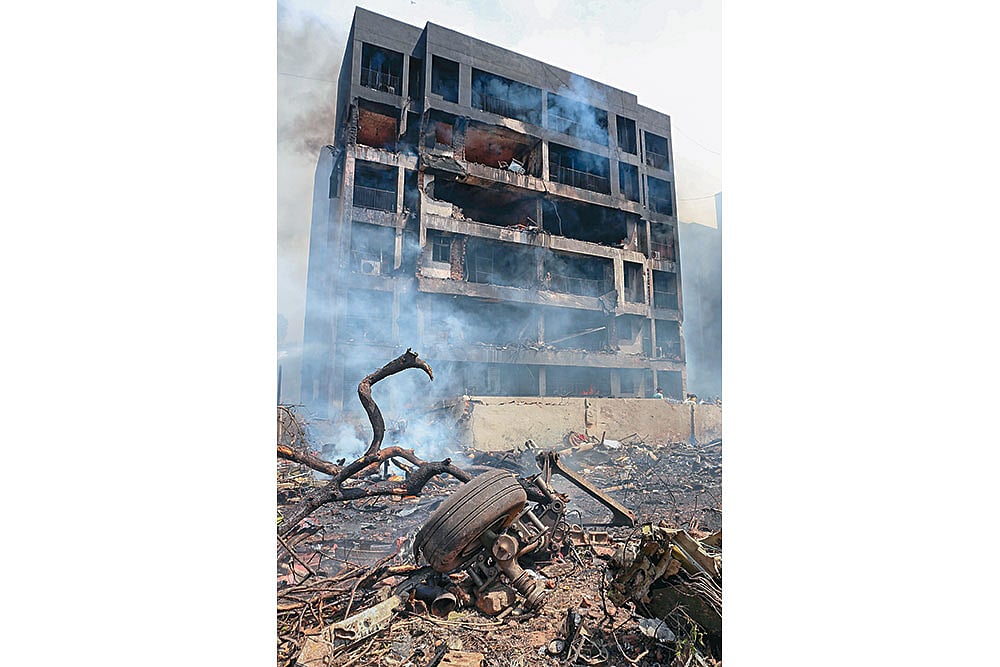 Remains of the plane seen in front of one of the residential buildings it crashed into 