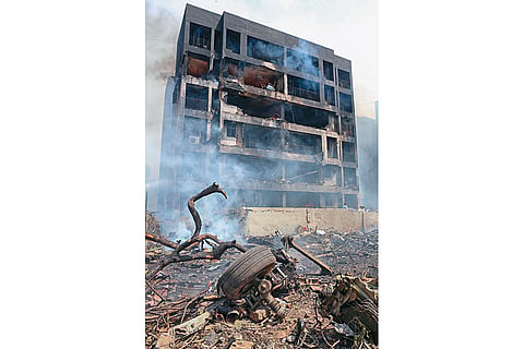 Fallen and Charred: Remains of the plane seen in front of one of the residential buildings it crashed into 