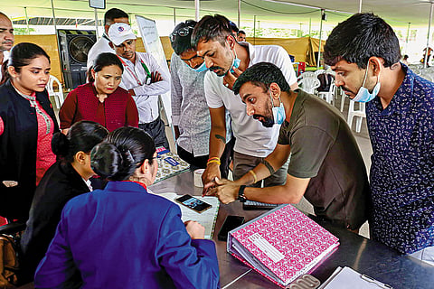 Losses and Miracles: Relatives of crash victims submit their documents at the Ahmedabad airport so that they can claim the belongings of their loved ones