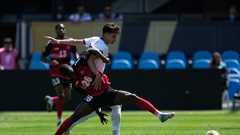 Trinidad and Tobago forward Isaiah Lee (26) reaches for the ball. AP