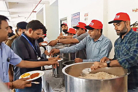 Crash Aftermath: Volunteers serving food to relief and rescue workers at the Civil Hospital