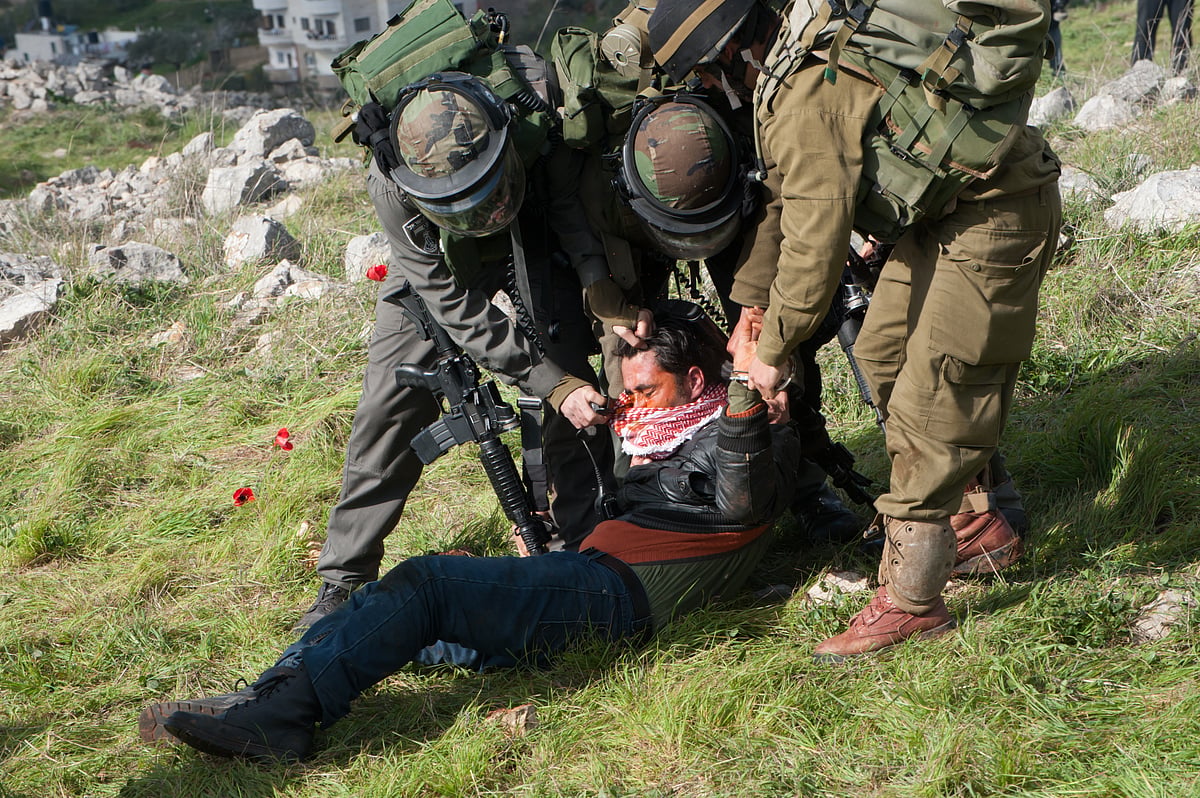 | Shutter Stock | : Israeli soldiers pepper spray a Palestinian man as they disperse a demonstration on land belonging to the West Bank village of Burin, February 2, 2013. 