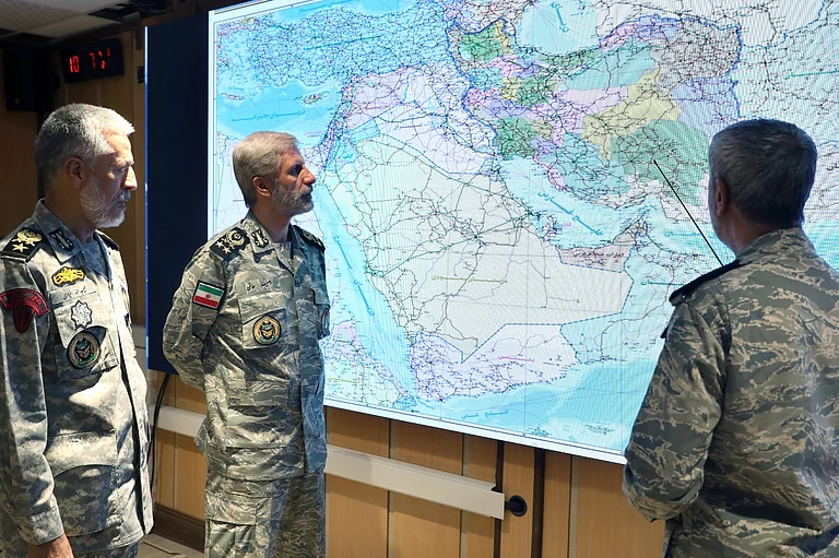 In this photo released on Monday, 23, 2025, by Iranian army press service, Iran's army commander-in-chief Gen. Amir Hatami, center, Admiral Mahmoud Mousavi, right, and Admiral Habibollah Sayyari attend a meeting in Zolfaghar central headquarters, Iran. - Iranian Army Press Service via AP