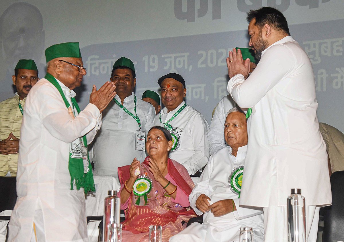 Patna: Newly appointed RJD's Bihar State President Mangnilal Mandal exchange greetings with party chief Lalu Prasad Yadav and Tejashwi Yadav during the Rashtriya Janata Dal State Council meeting, in Patna, Thursday, June 19, 2025. - PTI