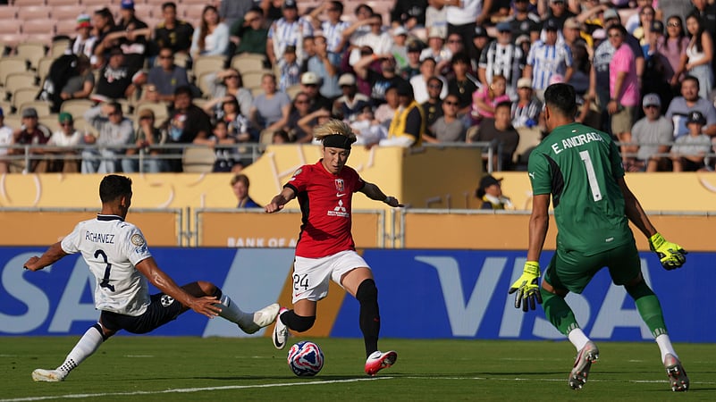 Urawa Red Diamonds Yusuke Matsuo, center, controls a ball challenged. AP
