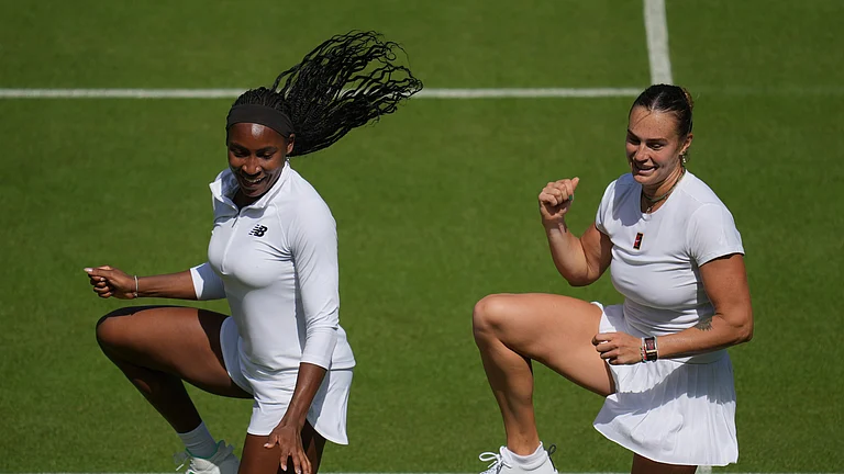 Aryna Sabalenka of Belarus, right, and Coco Gauff of United States dance during a practice session ahead of the Wimbledon Championships in London, Friday, June 27, 2025. - (AP Photo/Kin Cheung)