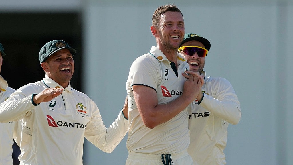 Photo: AP : Australia's Josh Hazlewood, centre, celebrates after taking the wicket of West Indies' Brandon King on day three of the first Test in Bridgetown, Barbados.