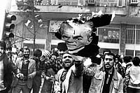 Many Folds Of The Persian Carpet | Photo: Getty Images : Troubled Past: Revolutionaries burning a portrait of Shah Mohammad Reza Pahlavi in Tehran during the Iranian Revolution in February 1978
