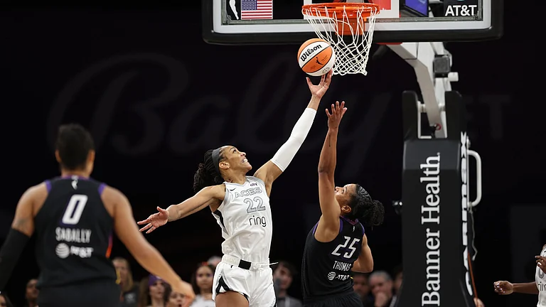 A'ja Wilson #22 of the Las Vegas Aces and Alyssa Thomas #25 of the Phoenix Mercury fight for the ball during the second half of the WNBA game at PHX Arena on June 29, 2025 in Phoenix, Arizona. - null
