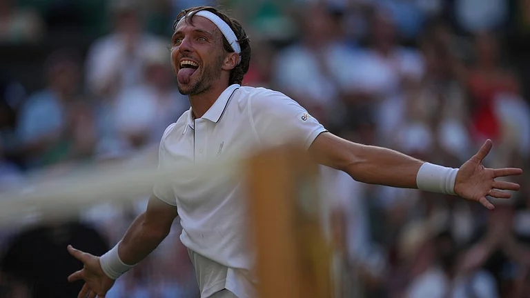 Arthur Rinderknech of France celebrates after beating Alexander Zverev of Germany in their first round men's singles match at the Wimbledon Tennis Championships in London, Tuesday, July 1, 2025. - AP/Kin Cheung