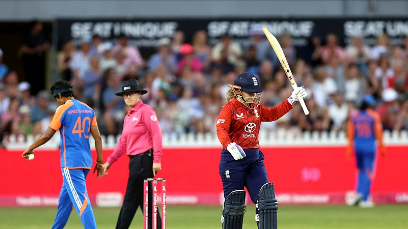 Englands Tammy Beaumont celebrates making fifty runs. AP