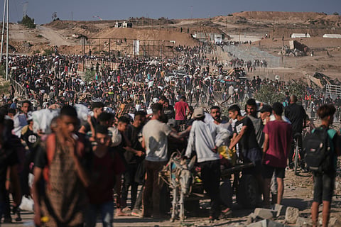 Palestinians carry humanitarian aid packages near the Gaza Humanitarian Foundation distribution center operated by the U.S.-backed organization in Khan Younis, southern Gaza Strip, Thursday, June 26, 2025. 