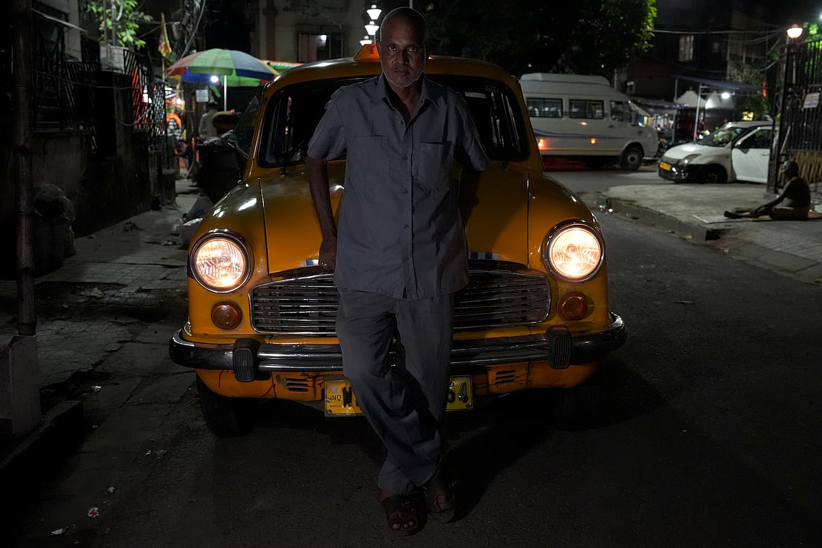 B. Kamath, a 52-year-old man from Madhubani district in Bihar, is considering driving a private car if taxis are discontinued. He lives with his wife and three sons. His eldest son works at a saree shop in Bangalore, while the other two sons are at home studying. He has been driving his current taxi is valid for more 2 years and 6 months. Kamath has been driving yellow taxis since 1987 and has a deep attachment to them.
