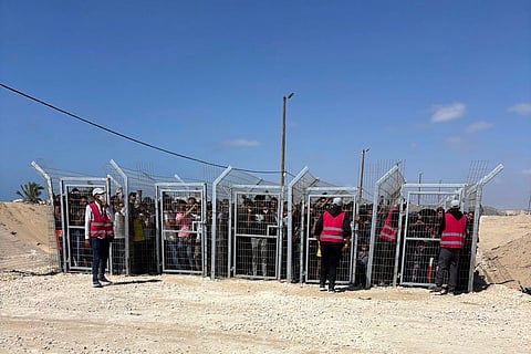 This photo, provided by an American contractor on condition of anonymity because they were revealing their employers’ internal operations, shows Palestinians behind gates before entering a food distribution site operated by the Gaza Humanitarian Foundation in May 2025, shortly after the start of the organization's distribution sites.