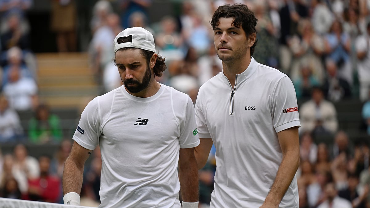 Taylor Fritz shakes hands with Jordan Thompson at the net