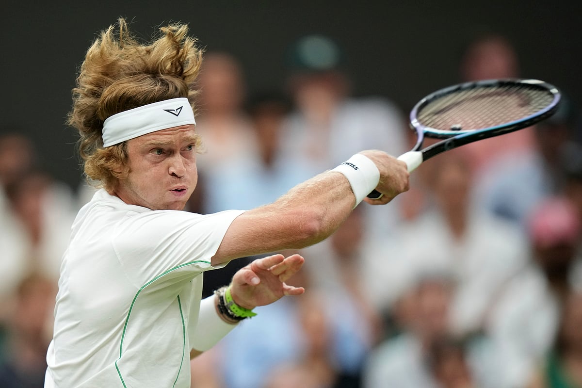 Russia's Andrey Rublev returns to Spain's Carlos Alcaraz during a fourth round men's singles match at the Wimbledon Tennis Championships in London, Sunday, July 6, 2025. 