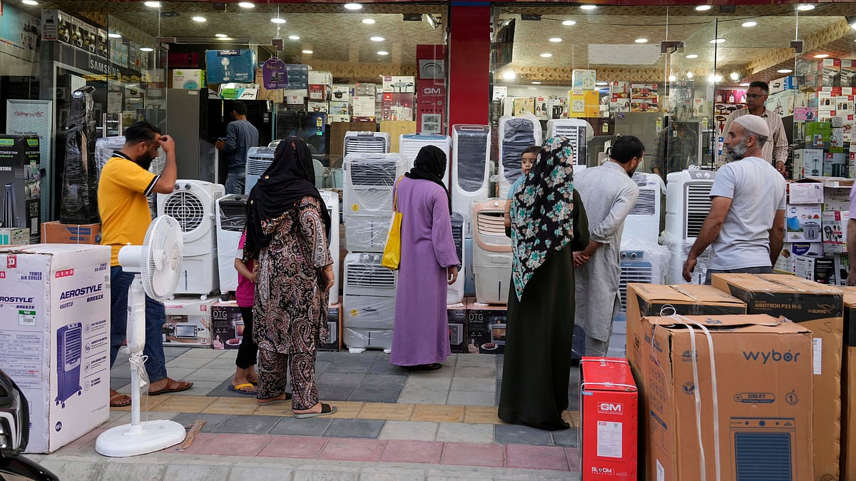 People purchase air conditioners at a shop on a hot summer day in Srinagar, Indian-controlled. 