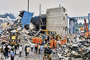| Photo: AP : The Day After: Rescue workers look for survivors at the explosion site