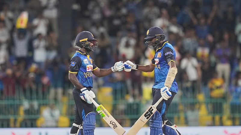 Sri Lankas Janith Liyanage, left, and Dushmantha Chameera bump fists. AP