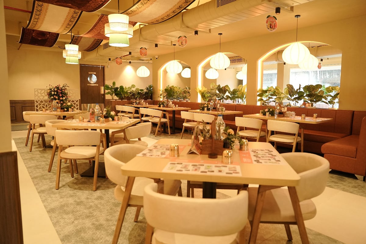Modern restaurant interior with warm lighting and well-appointed tables.