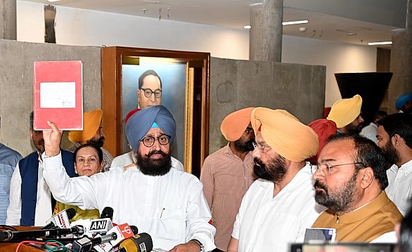 Photo by Ravi Kumar, via Getty Images : Leader of opposition Partap Singh Bajwa along with other congress MLAs interacting with the media after walking out from the budget session at Punjab Vidhan sabha on March 27, 2025 in Chandigarh. 