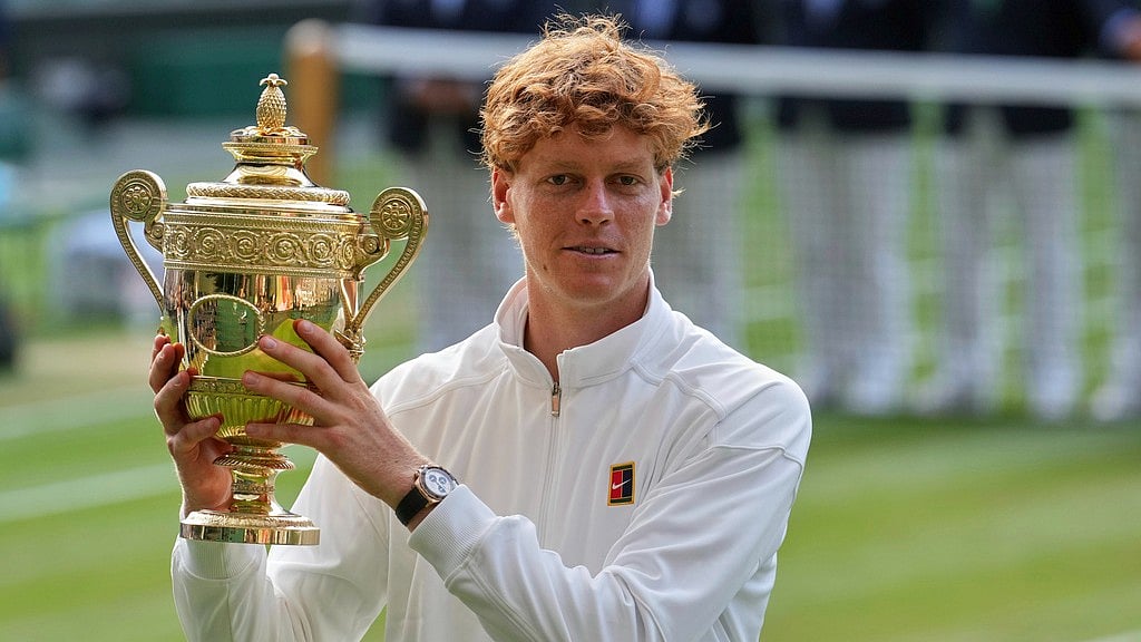 AP : Jannik Sinner vs Carlos Alcaraz, Wimbledon 2025 final: The Italian poses with the winner's trophy at the All England Club in London.