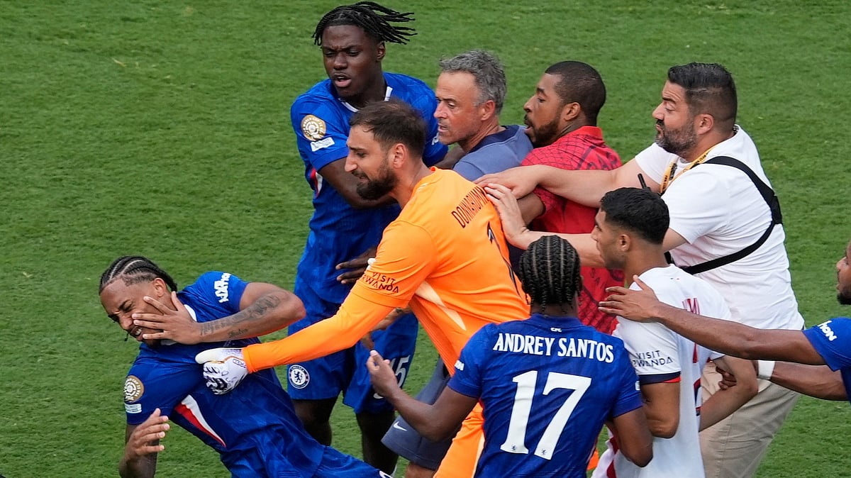 Chelsea's Joao Pedro, left, is attacked by Paris Saint-Germain's goalkeeper Gianluigi Donnarumma and coach Luis Enrique at the end of the Club World Cup final soccer match between Chelsea and PSG in East Rutherford, N.J., Sunday, July 13, 2025.
