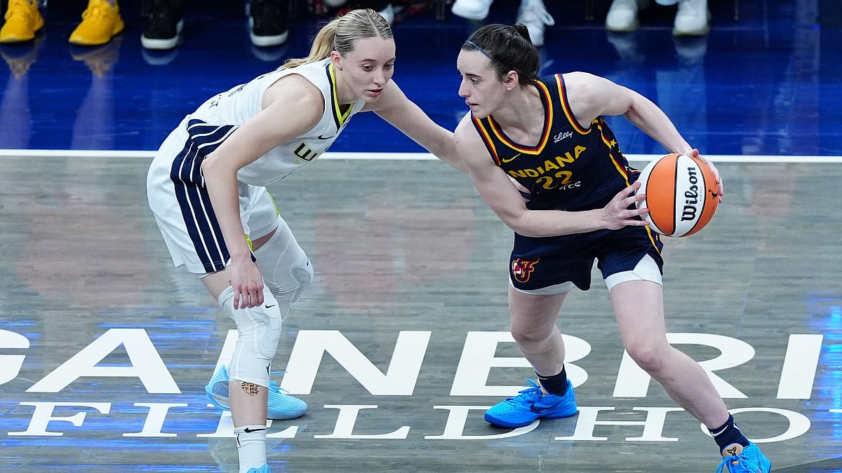 Indiana Fever guard Caitlin Clark (22) is guarded by Dallas Wings guard Paige Bueckers (5) on July 13, 2025, at Gainbridge Fieldhouse in Indianapolis, Indiana.
