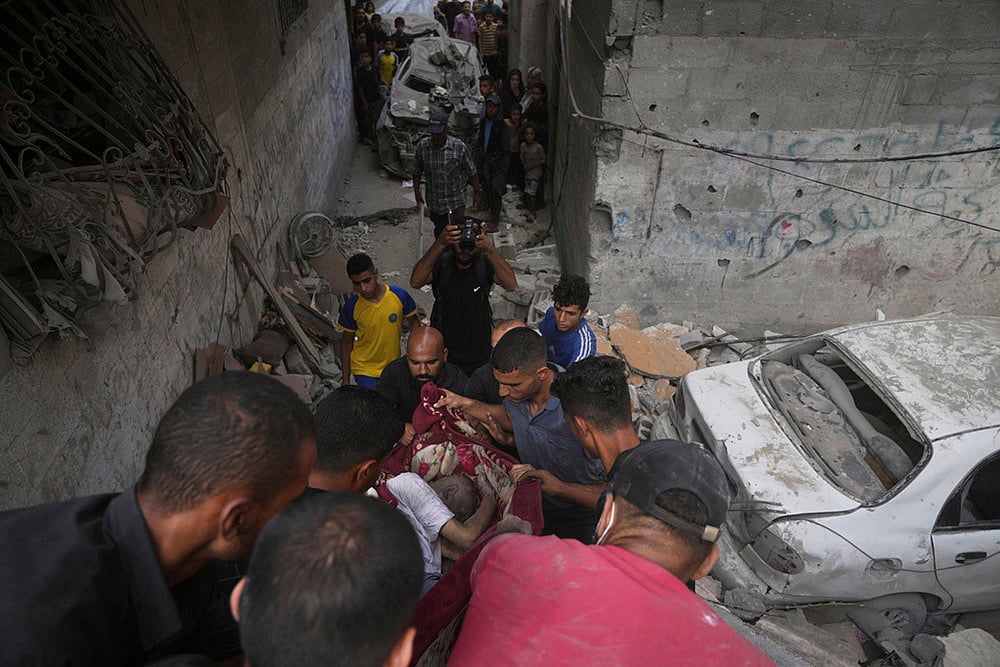 Israel-Palestine conflict in photo; body of a man is recovered after Israeli strike in Gaza