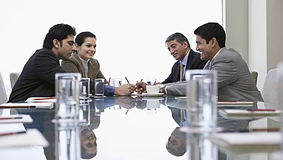 Business meeting with four professionals discussing loan plans