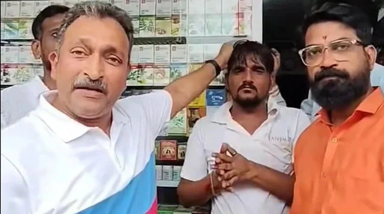 The video shows MNS workers, including party functionary Vishwajeet Dholam, confronting the shopkeeper. - Screen grab from the assault video going viral on social media.