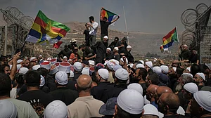 (AP Photo/Leo Correa) : Druze from Syria and Israel protest on the Israeli-Syrian border, in Majdal Shams in the Israeli-controlled Golan Heights, Wednesday, July 16, 2025, amid the ongoing clashes between Syrian government forces and Druze armed groups in the southern Syrian city of Sweida.