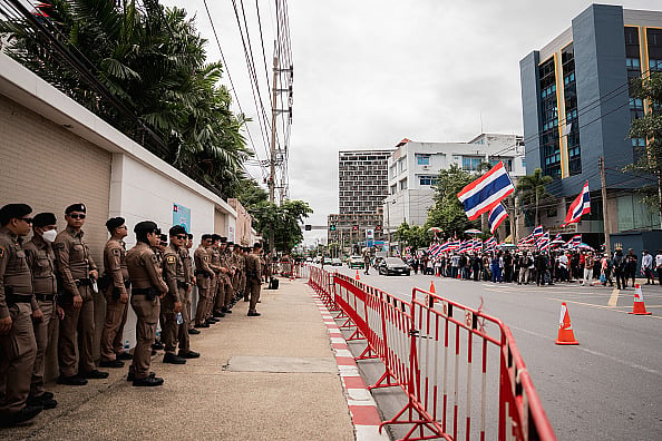 Thai police officers line up in front of the Cambodian Embassy in Bangkok as protesters gather across the street.  - (Photo by Ploy Phutpheng/SOPA Images/LightRocket via Getty Images)